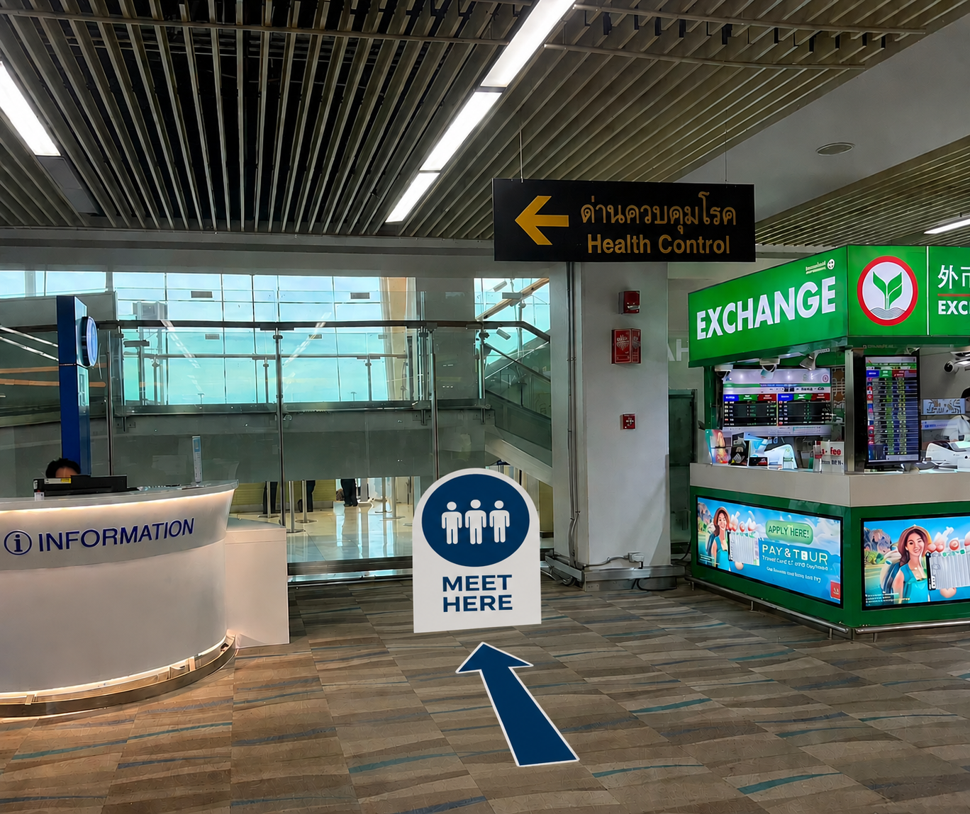Information desk and Meet Here sign in Phuket Airport arrivals hall