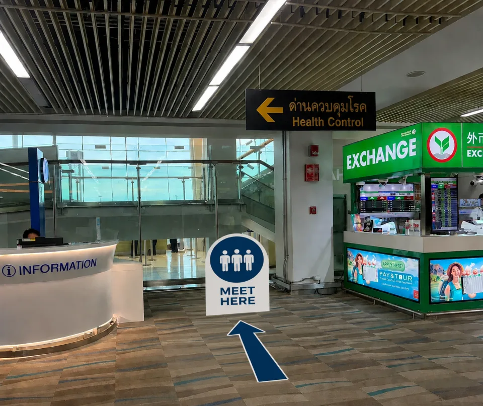Information desk and Meet Here sign in Phuket Airport arrivals hall
